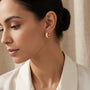 14K Gold Textured Heart Huggie Hoop Diamond Cut Earrings model still