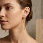 14K Yellow Gold Teardrop Geometric Diamond Cut Pattern Dangle Earrings model still