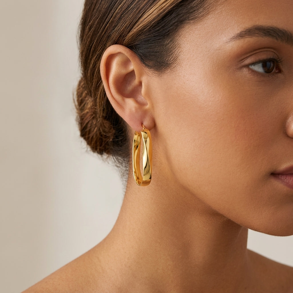 14K Twisted Oval Hoop Earrings model still
