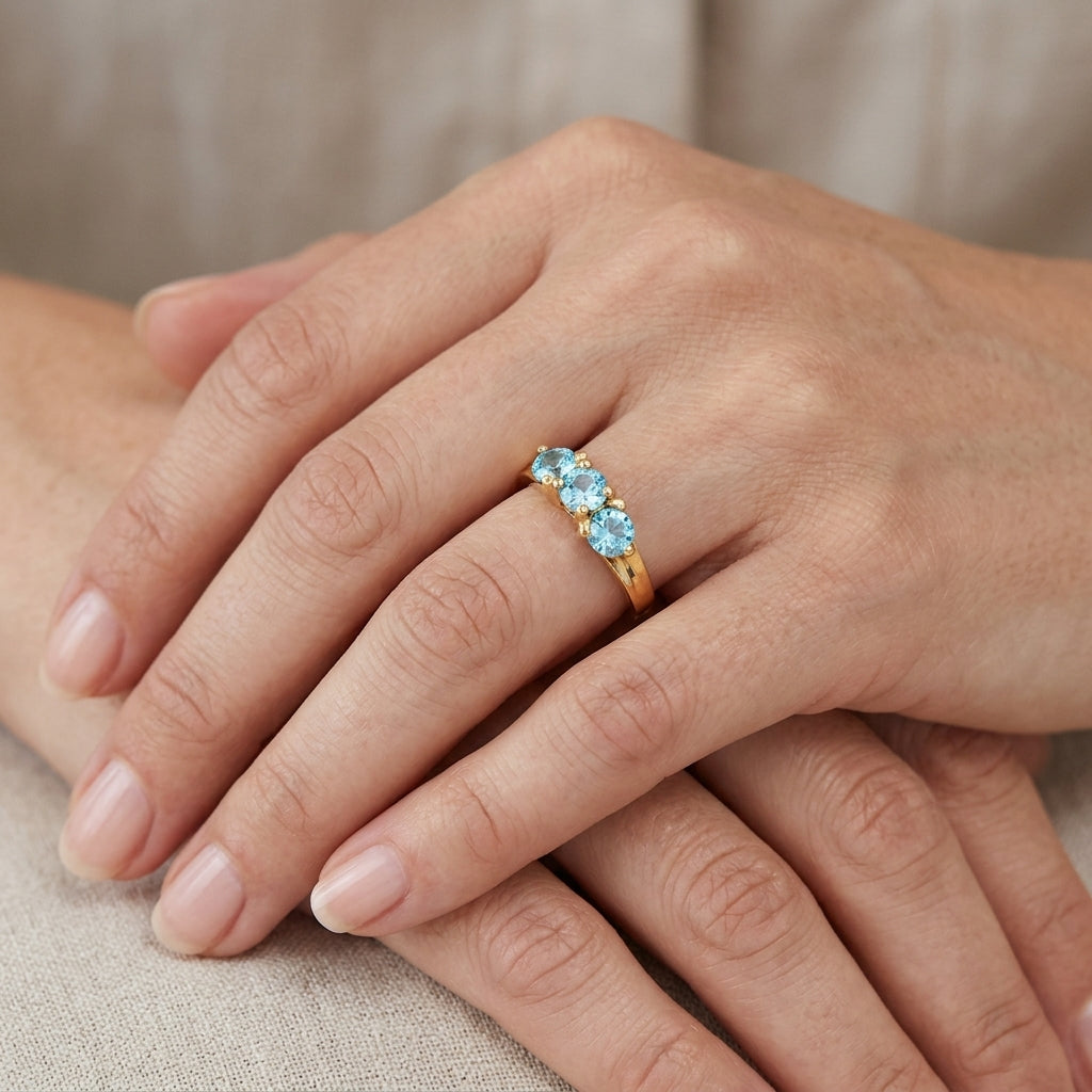 10K Yellow Gold Sky Blue Topaz Three Stone Ring model still