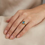 14K Yellow Gold Oval Blue Topaz Bypass Solitaire Ring model still