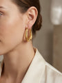 14K Textured Satin Finish Stylized Oval Hoop Earrings model still