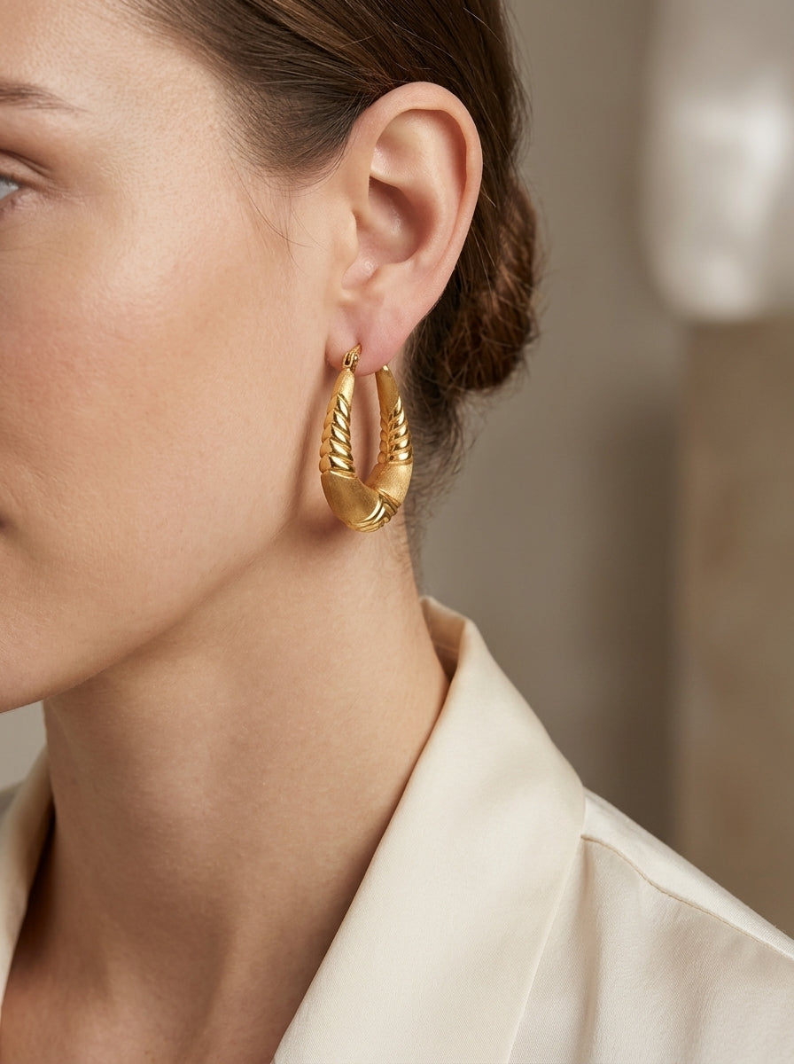 14K Textured Satin Finish Stylized Oval Hoop Earrings model still