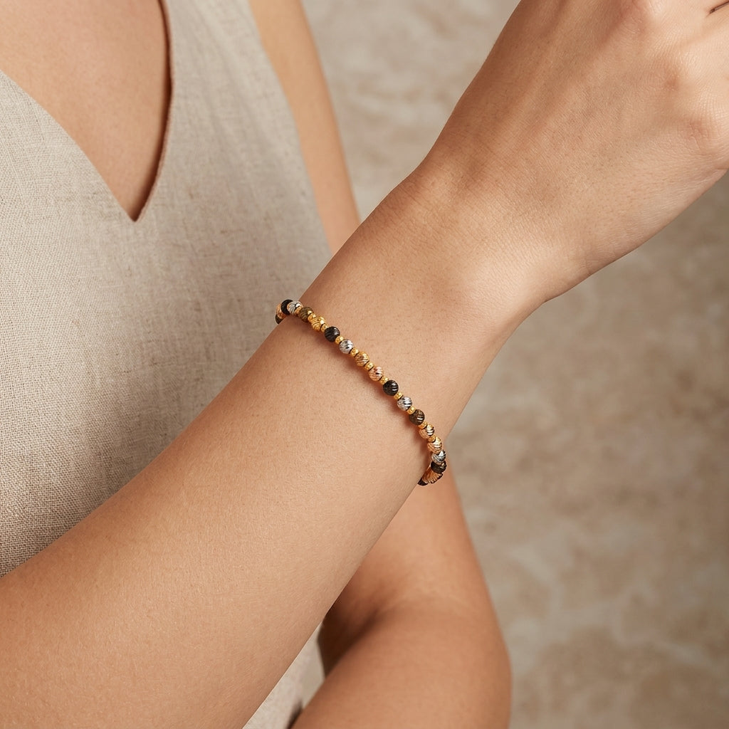 18K Multi Tone Gold Diamond Cut Bead Bracelet model still