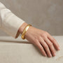 14K Yellow Gold Diamond Cut Textured Bangle Bracelet model still