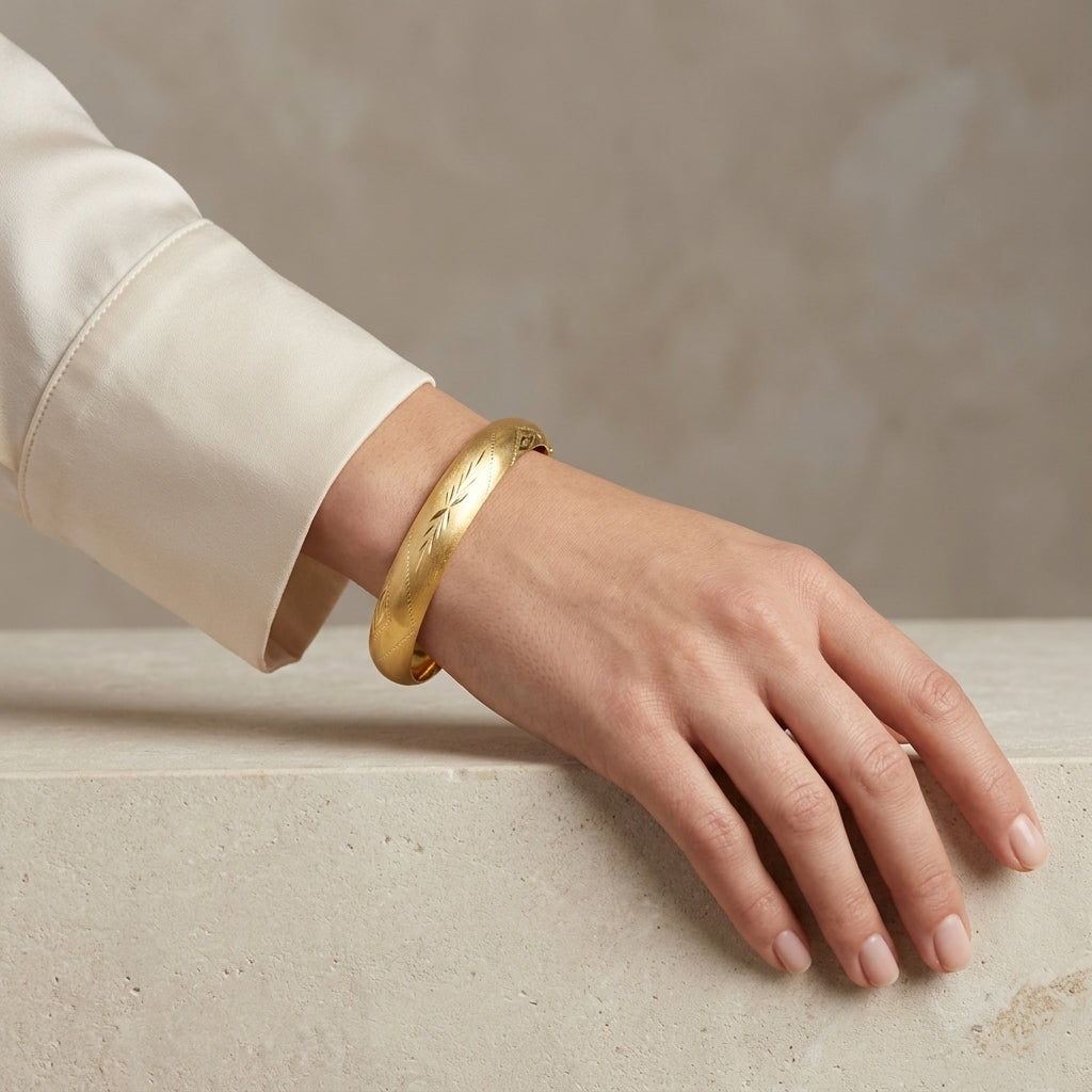 14K Yellow Gold Diamond Cut Textured Bangle Bracelet model still